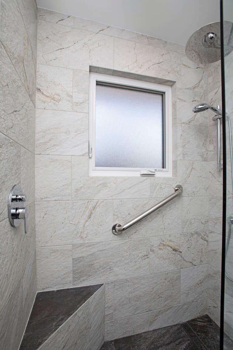 newly renovated shower with a waterproof window and grip bar