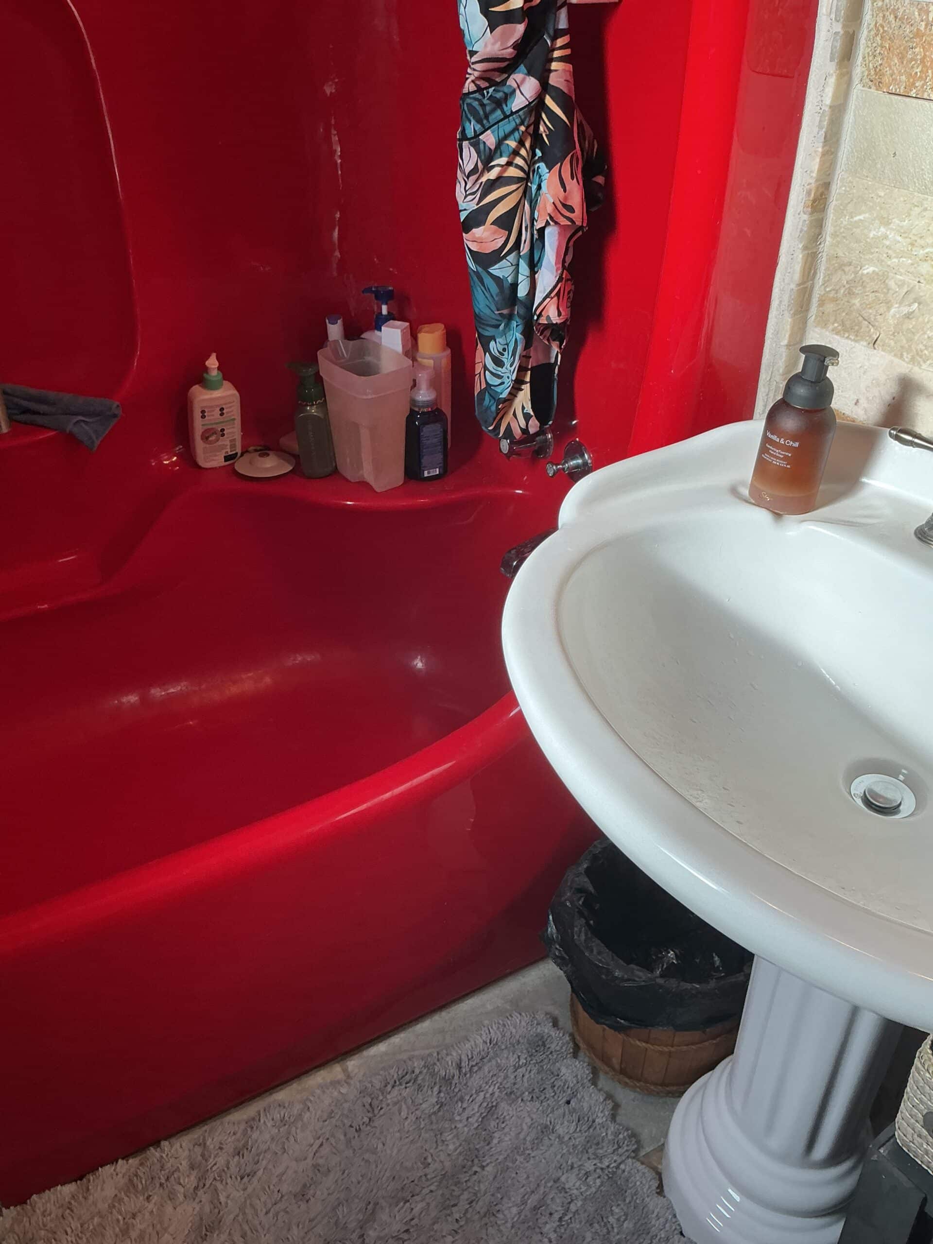 old bathroom with red bathtub before reno