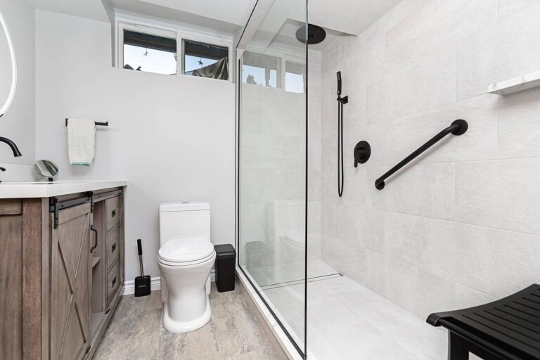 renovated bathroom with walk in shower with safety bars
